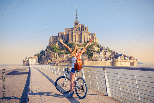 Woman with bicycle in Mont Saint Michel- Normandie in France