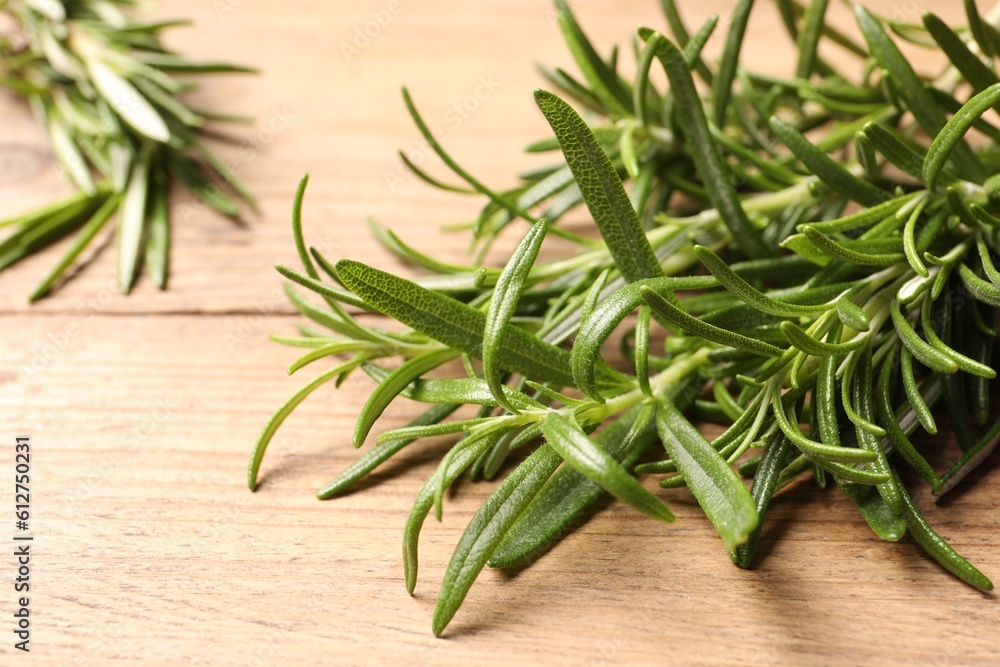 Fresh green rosemary on wooden table, closeup Fresh green rosemary on wooden table, closeup