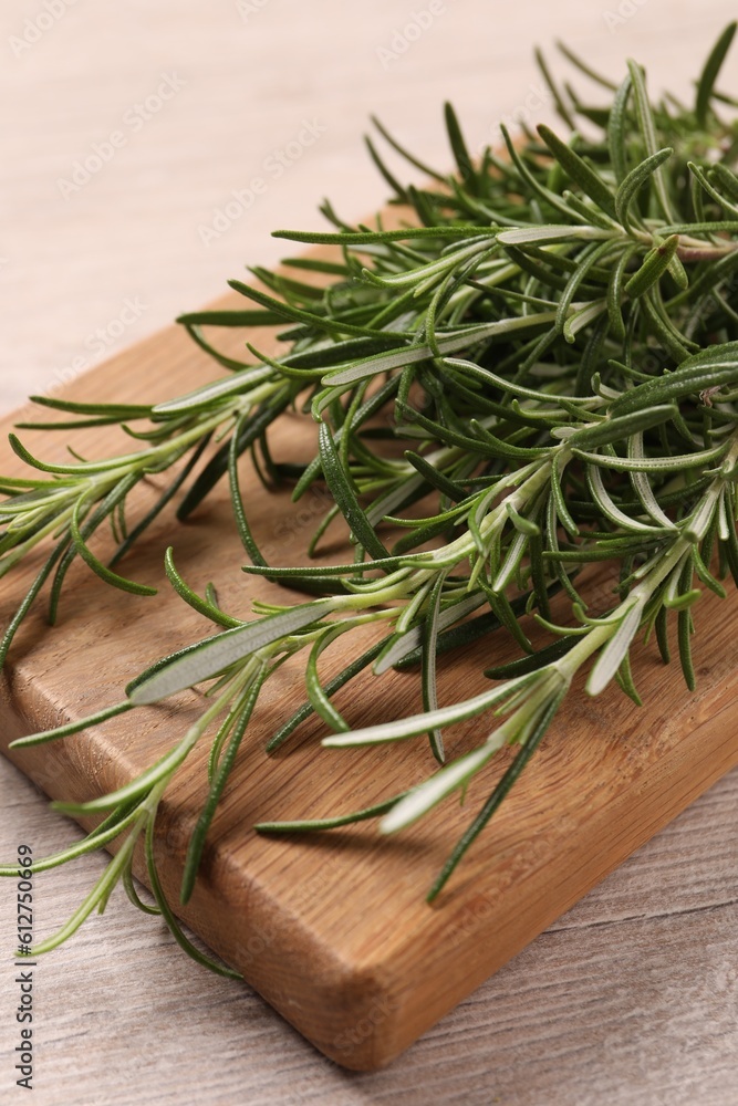 Sprigs of fresh rosemary on white wooden table, closeup Sprigs of fresh rosemary on white wooden table, closeup