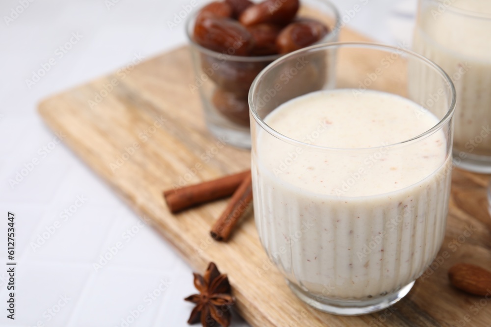 Glass of delicious date smoothie on white table, closeup. Space for text Glass of delicious date smoothie on white table, closeup. Space for text