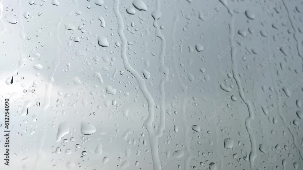 Rainwater drops Falling Down On the Window Glass. Rainwater drops Falling Down On the Window Glass.