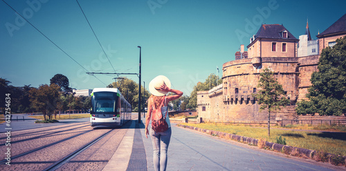 Woman in Nantes , Castle of the Dukes of Brittany and city tram- Europa- France