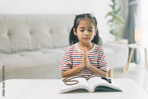 Little girl praying in the morning.Little asian girl hand praying,Hands folded in prayer concept for faith,spirituality and religion.