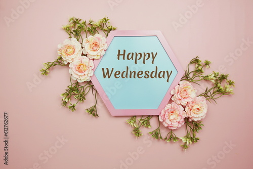 Happy Wednesday typography text decorate with flower on pink background