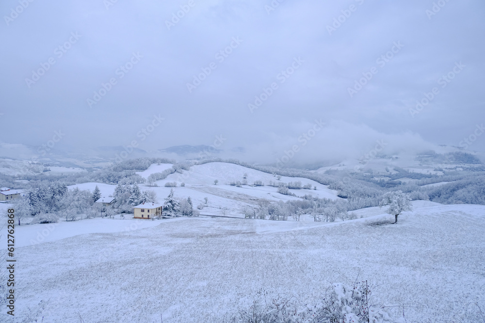 Blizzard in the mountains. Snowy hills, mountains, village, nature, horizon. Natural background. Appennino-Tosco-emiliano	
