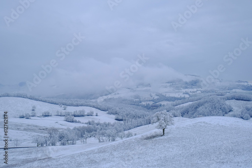 Blizzard in the mountains. Snowy hills, mountains, nature, horizon. Natural background. Appennino Tosco-emiliano