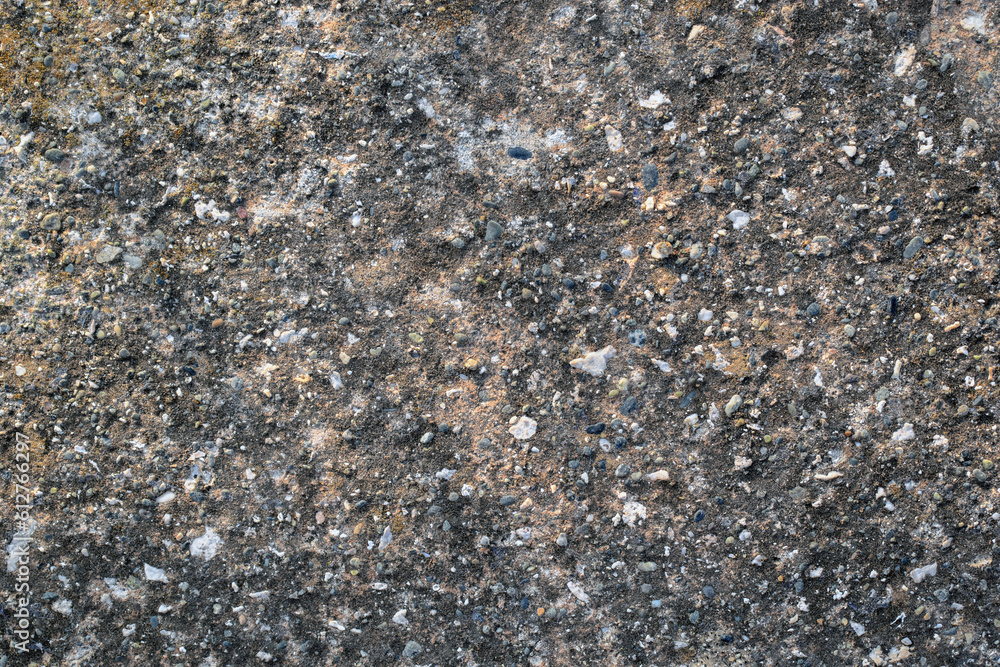 Dirty old concrete mixed with small gravel stones floor texture background. Black mold or mould on cement floor. Dirty old concrete mixed with small gravel stones floor texture background. Black mold or mould on cement floor.