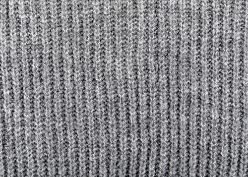 Wool knit texture in gray color. Background and texture. Close-up.