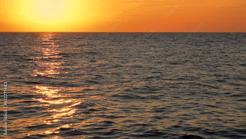 Sea waves with reflection of gold sunlight on the sunset background. Beautiful light of sun. Glowing on the sky, calm horizon scene by the sunny beach, mid shot, slow motion, hd. ProRes 422 HQ. Sea waves with reflection of gold sunlight on the sunset background. Beautiful light of sun. Glowing on the sky, calm horizon scene by the sunny beach, mid shot, slow motion, hd. ProRes 422 HQ.