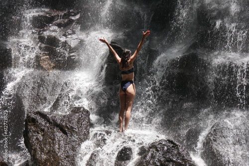 junge, Frau possiert am Kanto Lampo Wasserfall auf Bali photo