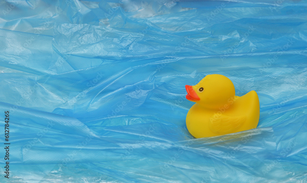 Pollution Plastic In Sea with Yellow Rubber Duck Toy and Plastic Waves