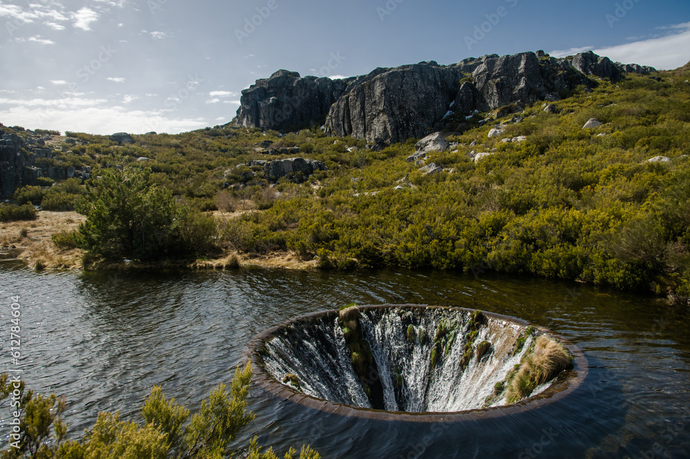 Discover the mesmerizing Covão dos Conchos, a captivating lake with a  distinctive hole, nestled in Serra da Estrela, Portugal. Majestic rocks and  lush bushes frame this enchanting natural wonder. Stock Photo |