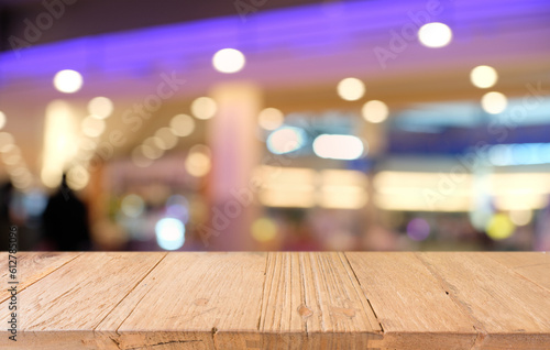 Empty wooden table in front of abstract blurred background of coffee shop . can be used for display or montage your products.Mock up for display of product.