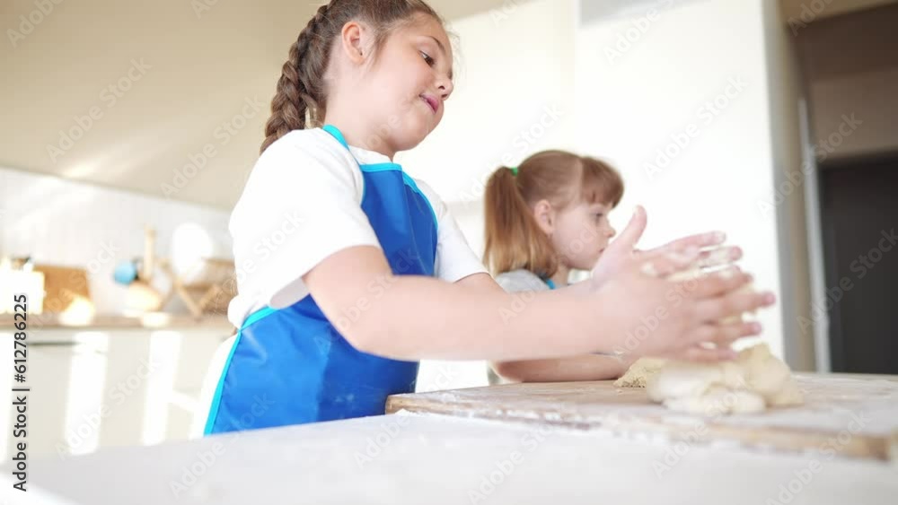kids are baking. children dream knead dough and flour in the kitchen. happy family kid concept. baby children bake pizza dough. sisters baking cookies. teamwork children knead dough and flour kids are baking. children dream knead dough and flour in the kitchen. happy family kid concept. baby children bake pizza dough. sisters baking cookies. teamwork children knead dough and flour