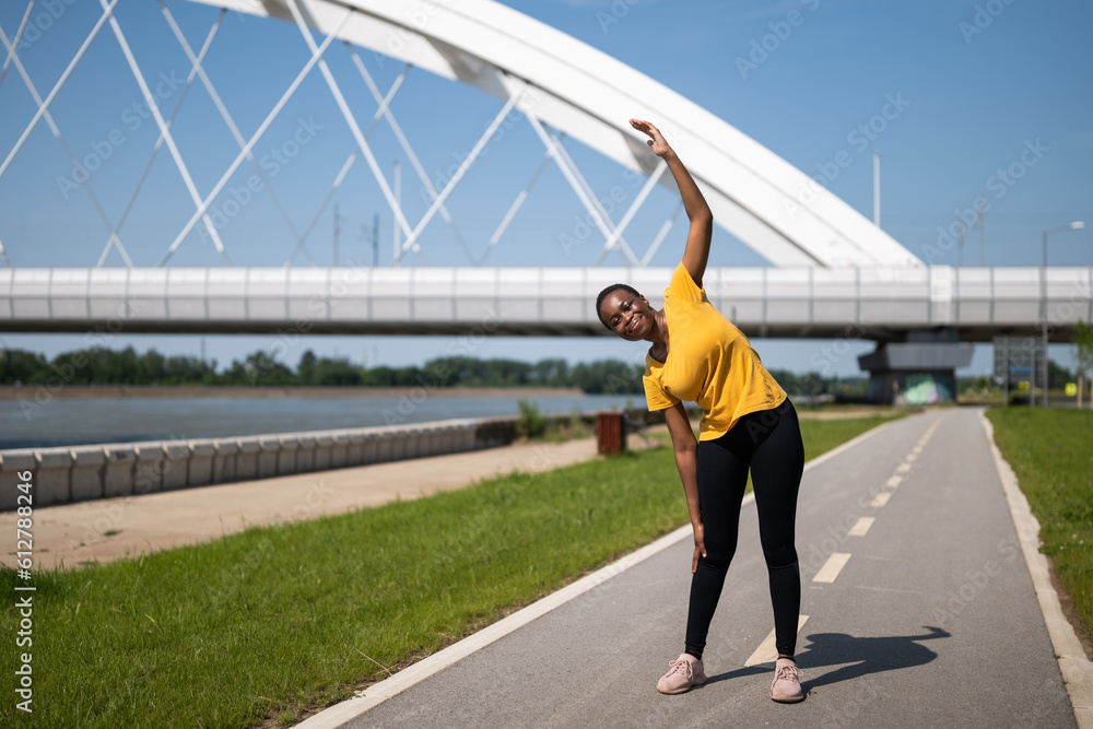 Young woman enjoys  exercising outdoor.