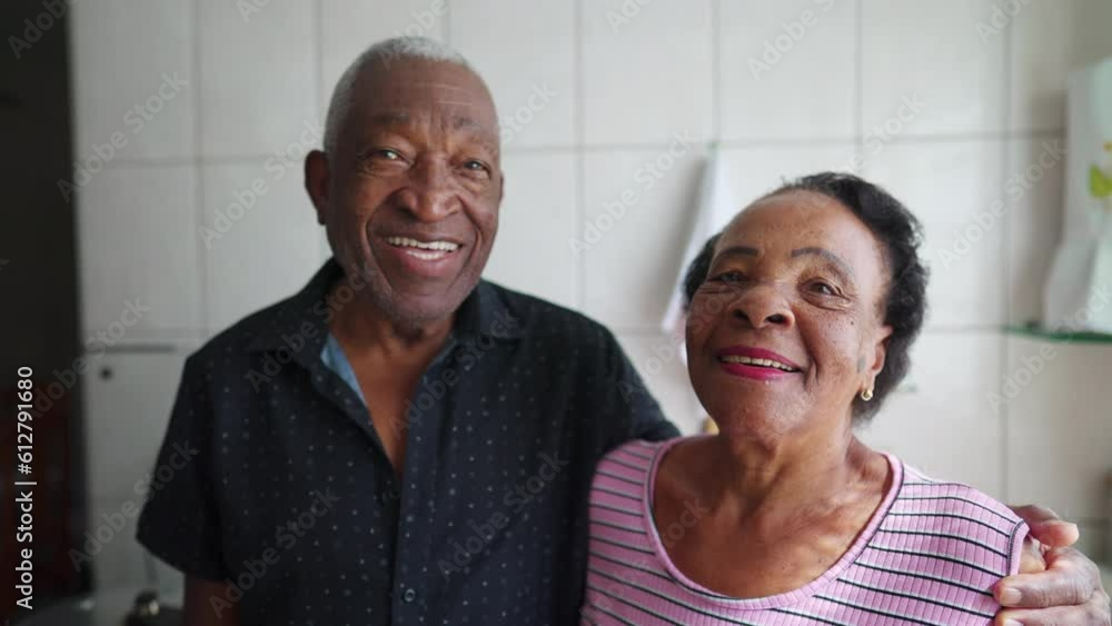 African American Senior Couple smiling at camera. A black elderly husband posing with arm around wife, close-up faces African American Senior Couple smiling at camera. A black elderly husband posing with arm around wife, close-up faces