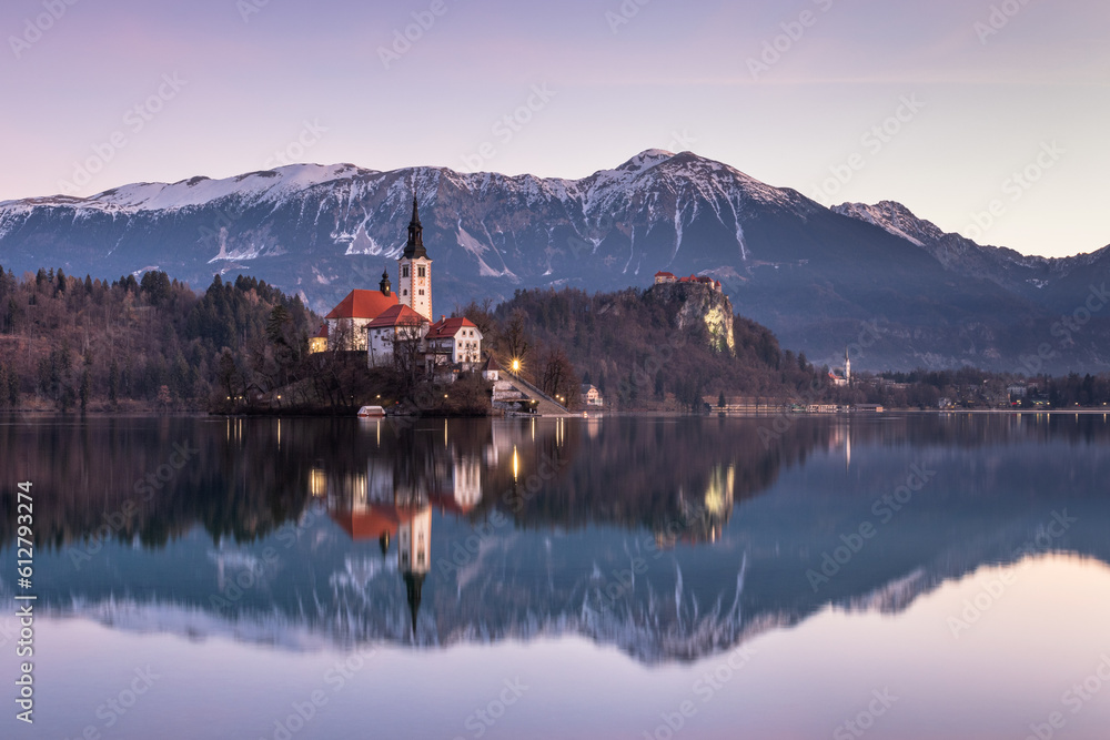 Sunrise reflections at Lake Bled with Bled Island and Bled Castle in the background. Sunrise reflections at Lake Bled with Bled Island and Bled Castle in the background.