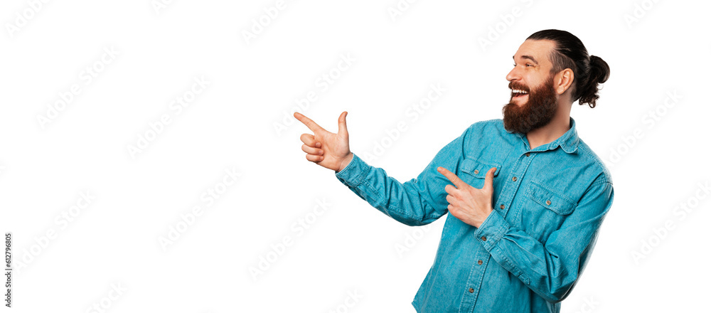 Cheerful bearded man is looking and pointing aside at white copy space. Cheerful bearded man is looking and pointing aside at white copy space.