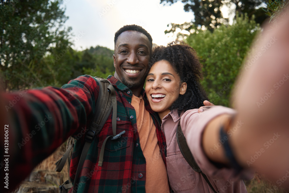 Young multiethnic couple smiling and taking selfies on a hiking trail Young multiethnic couple smiling and taking selfies on a hiking trail