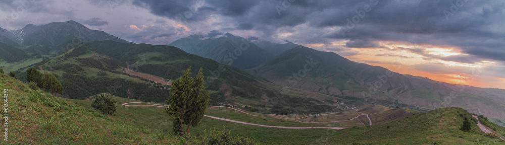 Mountain panorama of sunset sky and mountain road.