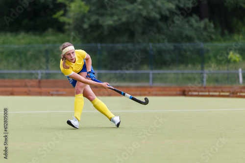 Field hockey player making pass to a teammate in a game