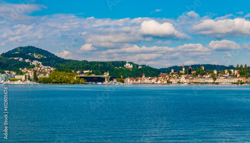 Panoramic view of Lucerne's waterfront from a boat on Lake Lucerne (Vierwaldstättersee). You can see the KKL building with the piers in front, the hotel Château Gütsch on the hill and the Old Town.