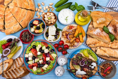 Traditional greek food on a blue wooden background.Flat lay