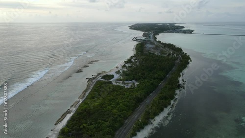 Aerial view of tropical beach landscape and local road at addu city, the southernmost atoll of Maldives in Indian ocean. Maldives tourism and summer vacation concepts. 4K footage drone video photo