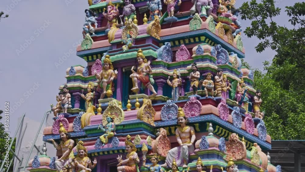 The Indian Hindu temple showcases a shikhara or tower adorned with god sculptures The Indian Hindu temple showcases a shikhara or tower adorned with god sculptures