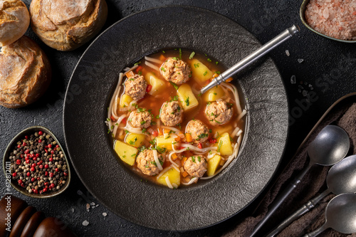 Top view of plate with meatballs soup, romanian traditional cuisine - Ciorba de perisoare.