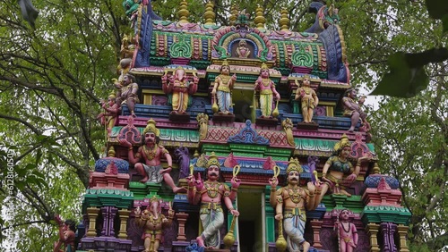 The Indian Hindu temple showcases a shikhara or tower adorned with god sculptures photo