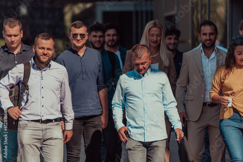A diverse group of businessmen and colleagues walking together by their workplace, showcasing collaboration and teamwork in the company.