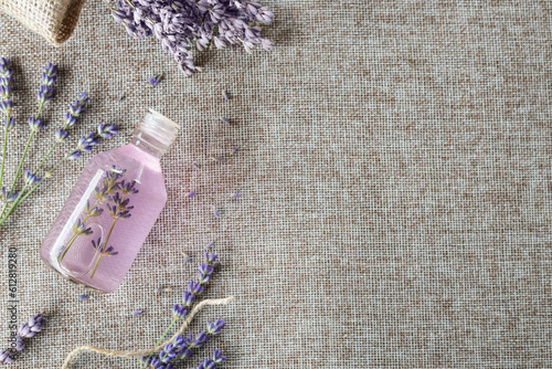 Aromatherapy aroma scented oil in glass bottles with fresh and dry lavender. Top view, flat lay, copy space for text.