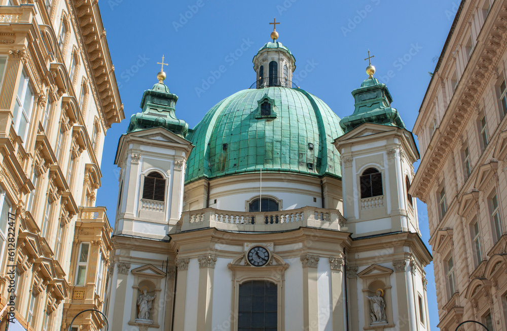Church among historical buildings in downtown Vienna, Austria, Central Europe. Ornaments and patterns of old houses. Exterior view of luxury and elegant neighborhood. European urban streetscape.