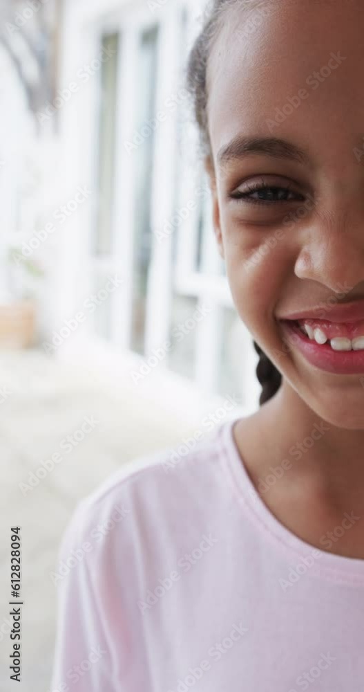 Vertical video of half portrait of biracial girl at home, slow motion Vertical video of half portrait of biracial girl at home, slow motion