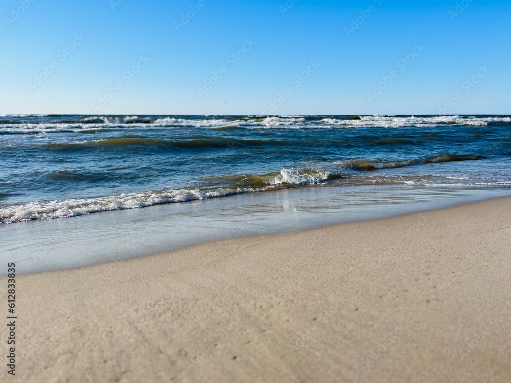 Blue seascape, waves on the sea, sandy coastline, empty beach Blue seascape, waves on the sea, sandy coastline, empty beach