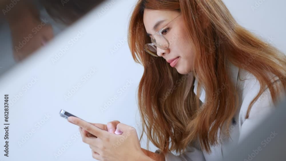 Experience the happiness and connection as a young Asian woman has fun chatting with friends on a mobile app. Vibrant videography capturing joyful moments of socializing and togetherness. Experience the happiness and connection as a young Asian woman has fun chatting with friends on a mobile app. Vibrant videography capturing joyful moments of socializing and togetherness.