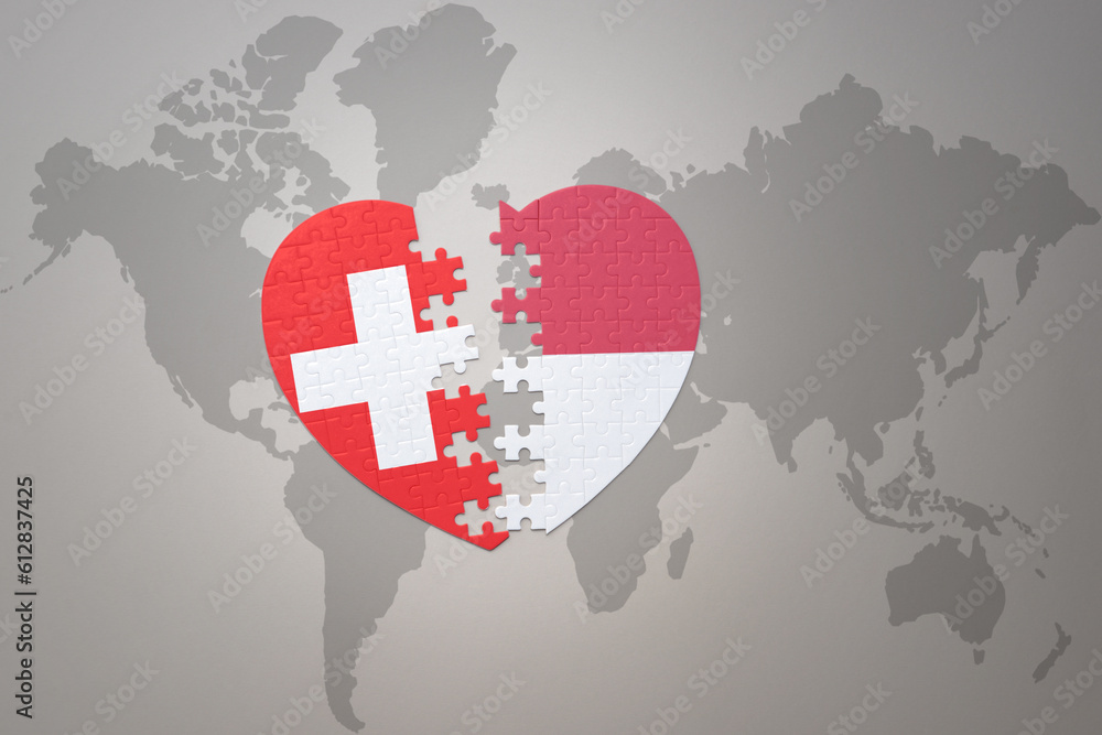 puzzle heart with the national flag of indonesia and switzerland on a ...
