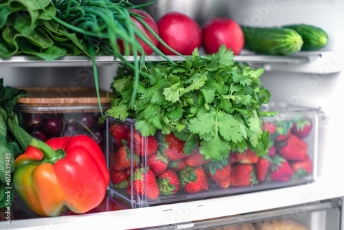 Open fridge full of fresh fruits and vegetables, vegetarian food healthy food background, greenery, organic nutrition, health care, dieting concept.