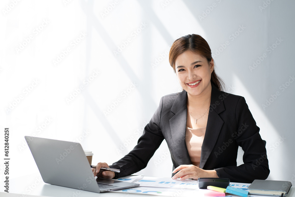 Young beautiful businesswoman working in the office room, using laptop computer on the office desk. Young beautiful businesswoman working in the office room, using laptop computer on the office desk.