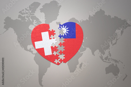 puzzle heart with the national flag of taiwan and switzerland on a world map background.Concept.