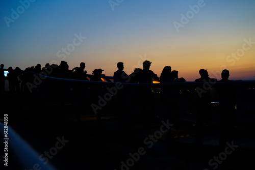Silouette of people watching the sunset