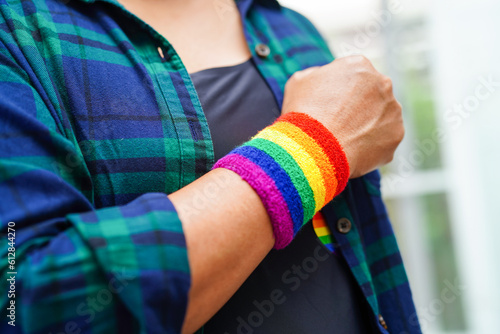 Asian woman with rainbow flag, LGBT symbol rights and gender equality, LGBT Pride Month in June.