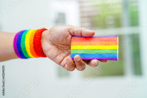 Asian woman with rainbow flag, LGBT symbol rights and gender equality, LGBT Pride Month in June, LGBTQ, LGBTI, LGBTQA, LGBTQIA