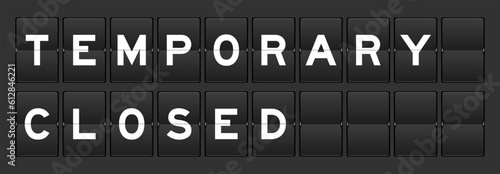 Black color analog flip board with word temporary closed on gray background