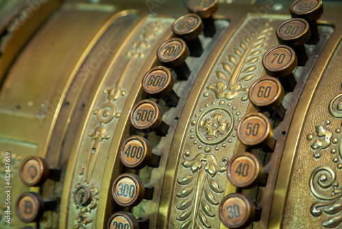Old Cash Register in close up shot. Green National Cash Register with numbers and details. Antique style cash register.
