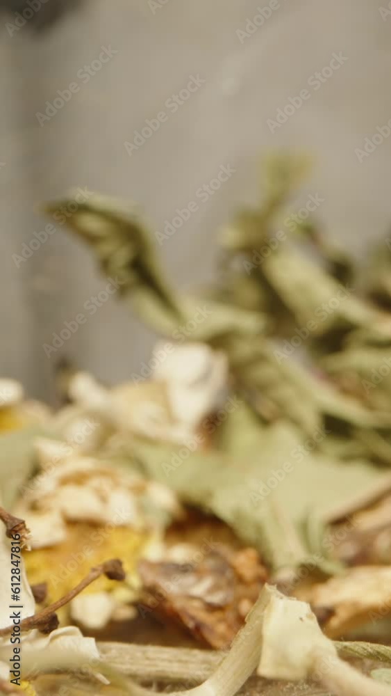 A tea ceremony, with scattered floral tea and brewing utensils on the table. Dolly slider extreme close-up. Vertical video. A tea ceremony, with scattered floral tea and brewing utensils on the table. Dolly slider extreme close-up. Vertical video.