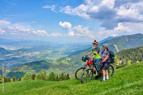 active senior couple on a mountain bike tour in the carinthian alps above Villach in Austria