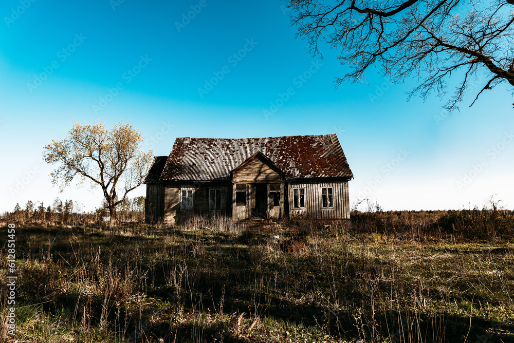 Abandoned 19th century house in a rural field at summer.Creepy summer evening. Abandoned 19th century house in a rural field at summer.Creepy summer evening.