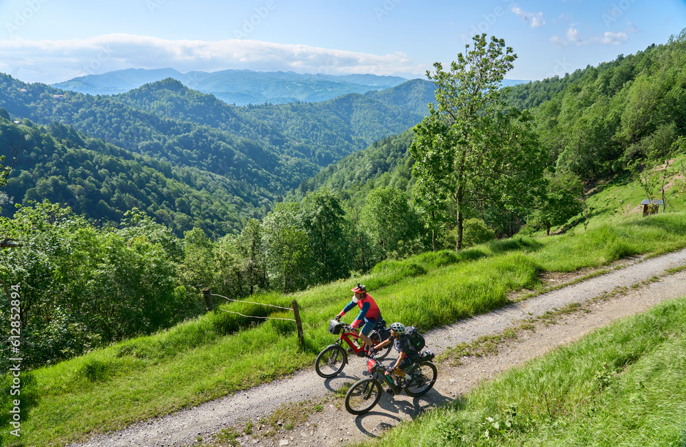 Obraz premium active senior couple on a bike tour with their electric mountain bikes in the Karst Mountains of Slovenia near Solkan